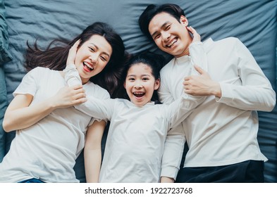 Happy Asian Family Portrait With Mother, Father And Daughter
