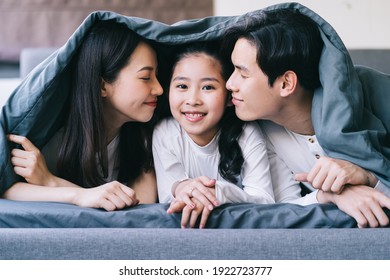 Happy Asian family portrait with mother, father and daughter
