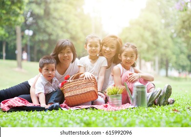 Happy Asian Family Portrait At Nature Park, Morning Outdoor With Sun Flare.