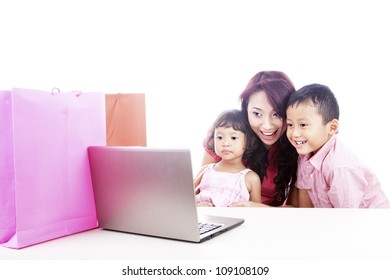 Happy Asian Family Shopping Online By Using Laptop Computer, Isolated On White