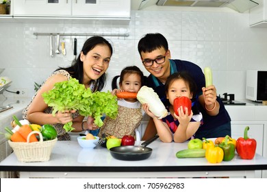 Happy Asian Family Show Vegetable In Hand, Eating Healthy Concept