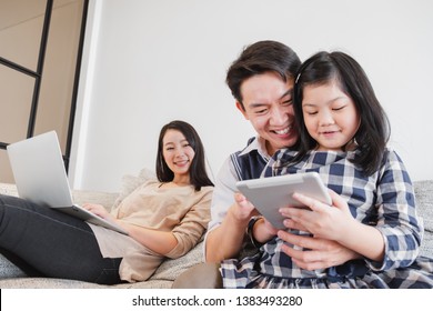 Happy Asian Family Spending Time Together At Home Playing Game, Tablet For Education