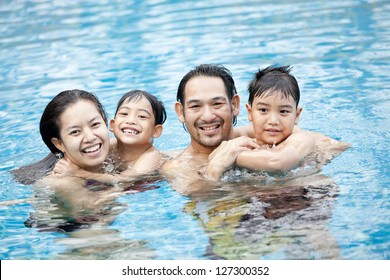 Happy Asian Family In Swimming Pool