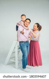 Happy asian family take a picture in a white background studio - Shutterstock ID 1803594607