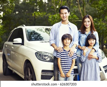 Happy Asian Family Taking A Photo During Trip.