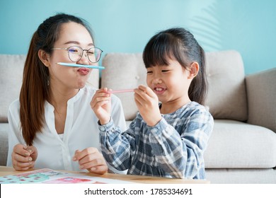  happy Asian family that has mother   daughter sitting playing enjoying   activity together at home   sunlight morning 