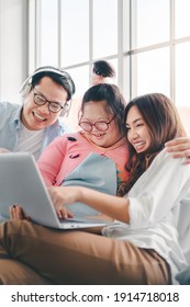 Happy Asian Family With Their Daughter Down Syndrome Child Sitting On Sofa  Have Fun Using Laptop Watch A Movie For Education , Enjoy Relax Timing Together, Activity Happy Family Lifestyle Concept.