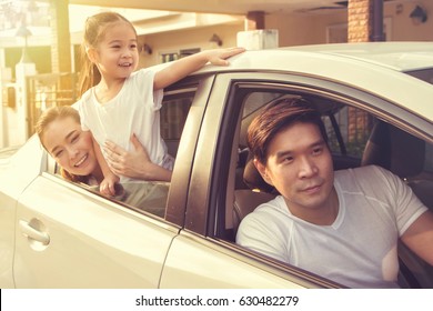 Happy Asian Family Traveling By Car.