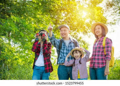 Happy Asian Family Trekking In Forest Together On Vacation.