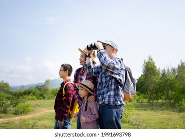 Happy Asian Family Trekking In Forest Together On Vacation.