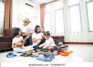Happy Asian Family Using Laptop Computer At Home Planning Vacation Travel Trip Togetherness Relaxation Concept