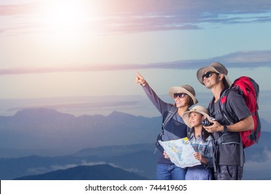 Happy Asian Family Walking In The Mountains. Concept Of Friendly Family Trip