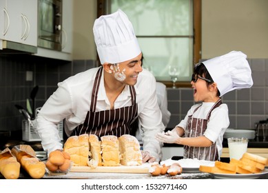 Happy Asian Father  With Cute Little Son In Chef  Hats  Preparing Cooking Bakery In Kitchen Room At Home , Family Healthy Lifestyle Concept