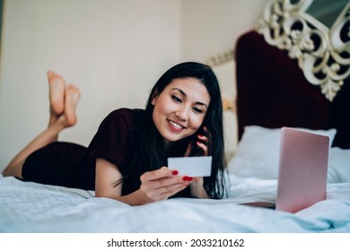 Happy Asian Female Freelancer With Laptop Computer Checking Mobile Contact On Business Card While Dialing Number And Calling, Cheerful Woman Phoning Via Cellphone Technology Talking And Smiling