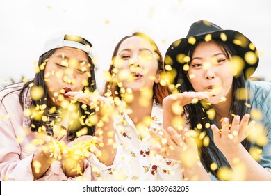 Happy Asian Friends Doing Party Throwing Confetti Outdoor - Young People Having Fun Celebrating At Festival Event Outside - Friendship, Fest, Entertainment And Youth Lifestyle Concept 