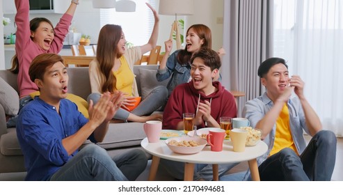 Happy Asian Friends Excited Cheering Watch Sport Streaming Tv Live Show In Living Room On Sofa