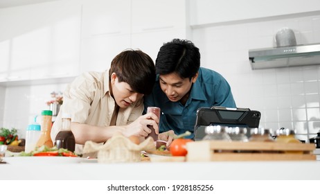 Happy Asian Gay Couple Cooking Sandwich Breakfast Together In Kitchen. Happy LGBTQ Family Doing Activity Together With Cheerful Enjoy At Home.