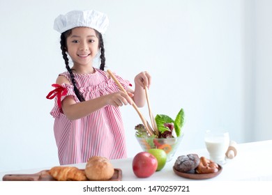 Happy Asian Girl Cooking Healthy Food, Smiling And Looking At Camera On White Background