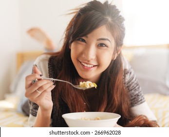 Happy Asian Girl Eating Chicken Noodle Soup