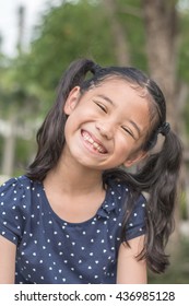 Happy Asian Girl Kid Showing Front Teeth With Big Smile