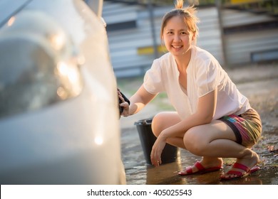 Happy Asian Girl Washing Car At Home