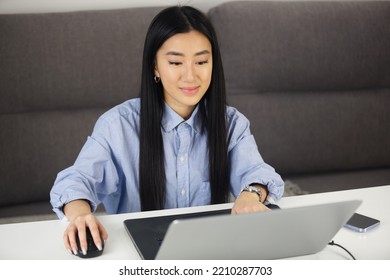 Happy Asian Girl Working On Laptop At Home. Cheerful Vietnamese Woman Doing Distant Work On Notebook Computer