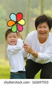 Happy Asian Grandmother With Grandson Child Playing Outdoor