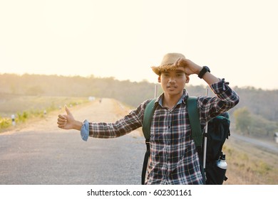 Happy Asian hipster man backpack in nature background, Relax time on holiday concept travel , color of vintage tone and soft focus  - Powered by Shutterstock