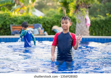 Happy Asian Kid Boy Swiming On Swiming Pool In The Summer