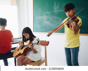 Happy Asian Kid Enjoy With Classic Music Class At School.