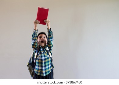 Happy Asian Kid Holding Book And Shoulder Bag