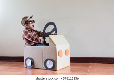 Happy Asian Kid Playing With Craft Paper Box At Home