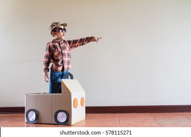 Happy Asian Kid Playing With Craft Paper Box At Home