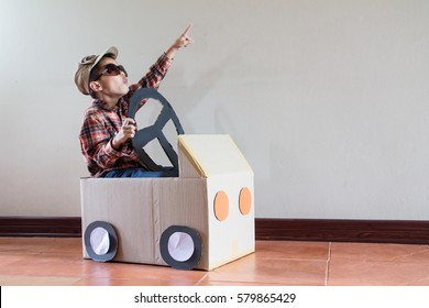 Happy Asian Kid Playing With Craft Paper Box At Home