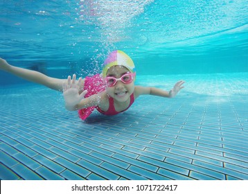 Happy Asian Kid Swimming Underwater In Summer. Outdoor Activities In Swimming Pool.