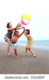 Happy Asian Kids Playing At The Beach