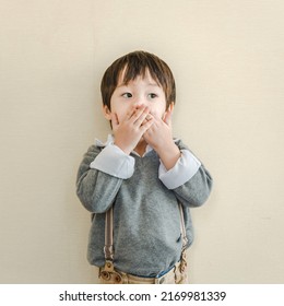 Happy Asian Little Boy Cover Mouth With Hand.