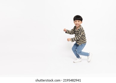 Happy Asian Little Boy Dancing Isolated On White Background, Full Length And Five Years Old