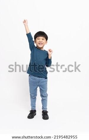 Happy Asian little boy hands up raised arms from happiness isolated on white background, Excited kid winner success concept, Looking at camera and full body composition