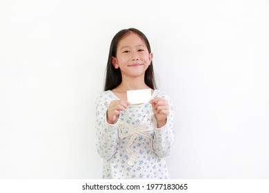 Happy Asian little girl child showing white card isolated on white background