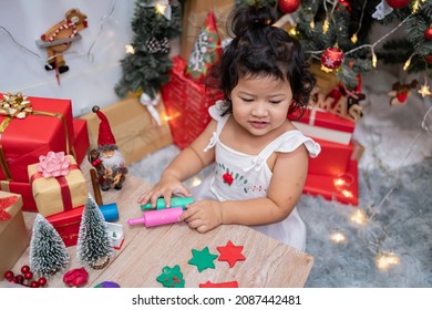 Happy Asian Little Girl Have Fun On Christmas Day. Kid With Parent With Christmas Tree Decoration At Home On Holiday.