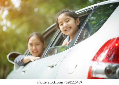 Happy Asian Little Girl Playing On Window Car With Mother, Family Traveling On Countryside