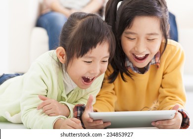 Happy Asian Little Girls Using Tablet Computer
