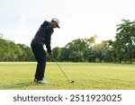 Happy Asian male amateur golfer is enjoy playing golf at the golf course in morning. Asian fat man going for a golf round.