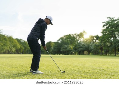 Happy Asian male amateur golfer is enjoy playing golf at the golf course in morning. Asian fat man going for a golf round. - Powered by Shutterstock