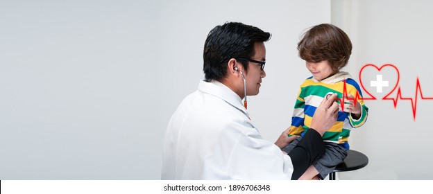 Happy Asian Male Doctor Hold Stethoscope Exam Child Boy Patient And Heart Rate Icon With Modern Virtual Screen Interface,healthcare Medical,Insurance For Your Health Concept.