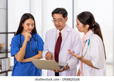 Happy Asian Male And Female Medical Doctor Team Standing And Meeting Discussion About Vaccine With Laptop Computer