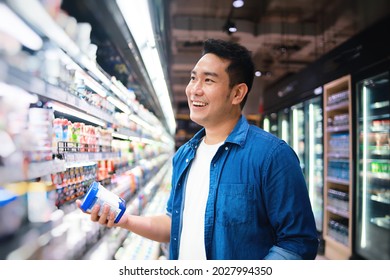 Happy Asian  Man In Casual Blue Shirt Shopping In Supermarket.