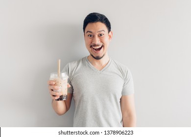 Happy Asian Man Is Drinking Bubble Milk Tea Or Pearl Milk Tea. Popular Milk Tea In Asia And Taiwan.