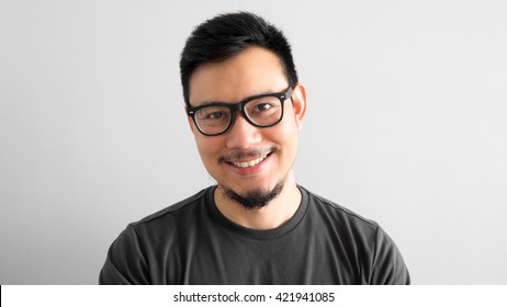 Happy Asian man with eyeglasses.